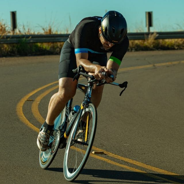 Man on road bicycle riding down road